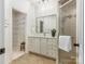 Bathroom with glass shower door and doorway to walk-in closet at 10333 Scott Gate Ct, Charlotte, NC 28277