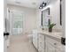 Well-lit bathroom with double sinks, a vanity, and a classic mirror design at 10333 Scott Gate Ct, Charlotte, NC 28277