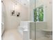 Modern bathroom showcasing a glass-enclosed shower and separate tiled tub with nature view at 10333 Scott Gate Ct, Charlotte, NC 28277