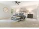 Large bedroom with ceiling fan, bedside tables, and multiple windows at 10333 Scott Gate Ct, Charlotte, NC 28277
