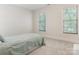Cozy bedroom featuring plush carpeting, natural light, and a comfortable bed at 10333 Scott Gate Ct, Charlotte, NC 28277