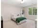 Comfortable bedroom with a twin bed, large window, and a white bookshelf at 10333 Scott Gate Ct, Charlotte, NC 28277