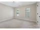 Bright and airy bedroom with neutral tones, lots of natural light, and soft carpet at 10333 Scott Gate Ct, Charlotte, NC 28277