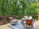 Outdoor deck featuring stylish furniture, a cozy rug, and a wooded backdrop at 10333 Scott Gate Ct, Charlotte, NC 28277