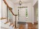 Bright foyer featuring a hardwood floor, staircase, and glass-paneled front door at 10333 Scott Gate Ct, Charlotte, NC 28277