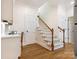 Hallway and staircase with wood flooring and white paneled doors at 10333 Scott Gate Ct, Charlotte, NC 28277