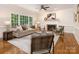 Cozy living room with a fireplace, large windows, and stylish furnishings at 10333 Scott Gate Ct, Charlotte, NC 28277