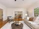 Open-concept living room with hardwood floors and views into the kitchen and dining area at 10333 Scott Gate Ct, Charlotte, NC 28277