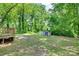 Large backyard with wooded area, shed, and access to deck at 104 W Maryland Ave, Bessemer City, NC 28016
