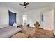 Bright bedroom with hardwood floors, ceiling fan, and closet at 104 W Maryland Ave, Bessemer City, NC 28016