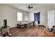 Bedroom featuring hardwood floors, white walls, and natural light from a window at 104 W Maryland Ave, Bessemer City, NC 28016