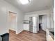 View of the updated kitchen area with stainless steel refrigerator and granite countertops at 104 W Maryland Ave, Bessemer City, NC 28016
