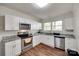 Modern kitchen with stainless steel appliances, white cabinetry, and granite countertops at 104 W Maryland Ave, Bessemer City, NC 28016