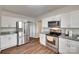 Modern kitchen with stainless steel appliances, white cabinets, and granite countertops at 104 W Maryland Ave, Bessemer City, NC 28016