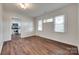 Open living room with hardwood floors, access to the kitchen, and bright windows at 104 W Maryland Ave, Bessemer City, NC 28016
