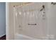 Clean white shower with handheld shower head, grab bar, and clear curtain at 104 W Maryland Ave, Bessemer City, NC 28016