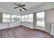 Bright sunroom featuring wood floors, large windows, and a ceiling fan at 104 W Maryland Ave, Bessemer City, NC 28016