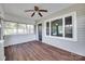 Sunroom boasts wood floors, great windows, and a ceiling fan at 104 W Maryland Ave, Bessemer City, NC 28016