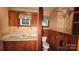 Small bathroom featuring a sink, toilet, and wood paneling at 11056 Us Highway 52 N Hwy, Wadesboro, NC 28170