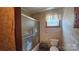 Compact bathroom with swan-themed shower door, toilet, and patterned wallpaper at 11056 Us Highway 52 N Hwy, Wadesboro, NC 28170