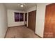 Bedroom with wood closet doors, carpet flooring, and window at 11056 Us Highway 52 N Hwy, Wadesboro, NC 28170
