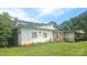 Side view of a two story home featuring brick and white painted exteriors and large front yard at 11056 Us Highway 52 N Hwy, Wadesboro, NC 28170
