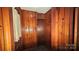 Narrow hallway featuring wood paneling and a small closet at 11056 Us Highway 52 N Hwy, Wadesboro, NC 28170