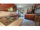 View of kitchen featuring wooden cabinets, linoleum countertop, and washer-dryer at 11056 Us Highway 52 N Hwy, Wadesboro, NC 28170