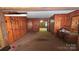View of paneled Living Room with carpet flooring and entrance to front room at 11056 Us Highway 52 N Hwy, Wadesboro, NC 28170
