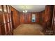 Classic living room featuring wood paneling, carpeted floors, and natural light at 11056 Us Highway 52 N Hwy, Wadesboro, NC 28170