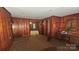 Cozy living room with wood paneling, carpeted floors, and multiple entryways at 11056 Us Highway 52 N Hwy, Wadesboro, NC 28170
