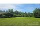 Expansive grassy area perfect for a homesite surrounded by mature trees and lush landscaping at 11056 Us Highway 52 N Hwy, Wadesboro, NC 28170