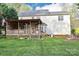 Expansive backyard with a deck, play area, fire pit and mature trees at 111 Painted Bunting Dr, Troutman, NC 28166