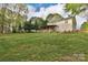 Spacious backyard featuring a covered deck, fenced in area and plenty of green space at 111 Painted Bunting Dr, Troutman, NC 28166