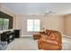 Bonus room features a sectional couch, TV, ceiling fan, and a window providing natural light at 111 Painted Bunting Dr, Troutman, NC 28166