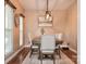 This dining room features a modern chandelier, a wooden table, and neutral-colored chairs at 111 Painted Bunting Dr, Troutman, NC 28166