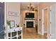 Inviting foyer with tiled floor, a decorative table, and a view of the fireplace and living room at 111 Painted Bunting Dr, Troutman, NC 28166