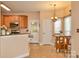Open kitchen featuring appliances, tile flooring, eat in area, and access to outdoor area at 111 Painted Bunting Dr, Troutman, NC 28166