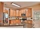 Well-equipped kitchen featuring wooden cabinets and countertops with modern stainless steel appliances at 111 Painted Bunting Dr, Troutman, NC 28166
