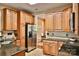 Spacious kitchen featuring stainless steel refrigerator, wooden cabinets and eat in dining at 111 Painted Bunting Dr, Troutman, NC 28166