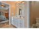 This bathroom features double sinks, a large mirror, and access to the toilet and main bedroom at 111 Painted Bunting Dr, Troutman, NC 28166