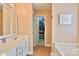 This main bathroom features a double vanity sink, bathtub, walk-in closet, and modern fixtures at 111 Painted Bunting Dr, Troutman, NC 28166