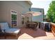 Relax on this back deck with a patio table, umbrella, grill, and comfortable chair at 1125 Victoria Blake Ln, Belmont, NC 28012