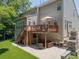 Spacious backyard boasting an elevated deck, a lower patio with outdoor seating, and lush green landscaping at 1125 Victoria Blake Ln, Belmont, NC 28012