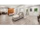 Comfortable finished basement featuring a sitting area, dining set, and a large sliding barn door at 1125 Victoria Blake Ln, Belmont, NC 28012