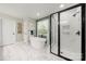 Bright bathroom featuring a modern soaking tub, a glass enclosed shower, and marble floors at 1125 Victoria Blake Ln, Belmont, NC 28012