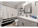 A modern bathroom offers a sleek vanity with a black faucet and decorative shelving near the framed mirror at 1125 Victoria Blake Ln, Belmont, NC 28012