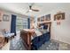 Bright bedroom with sports themed decor, a ceiling fan, and a large window at 1125 Victoria Blake Ln, Belmont, NC 28012