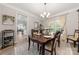 Cozy dining room featuring a wood table, chandelier, and view of living room through the doorway at 1125 Victoria Blake Ln, Belmont, NC 28012