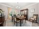 Elegant dining room with chandelier, mahogany dining set, and decorative china cabinet at 1125 Victoria Blake Ln, Belmont, NC 28012